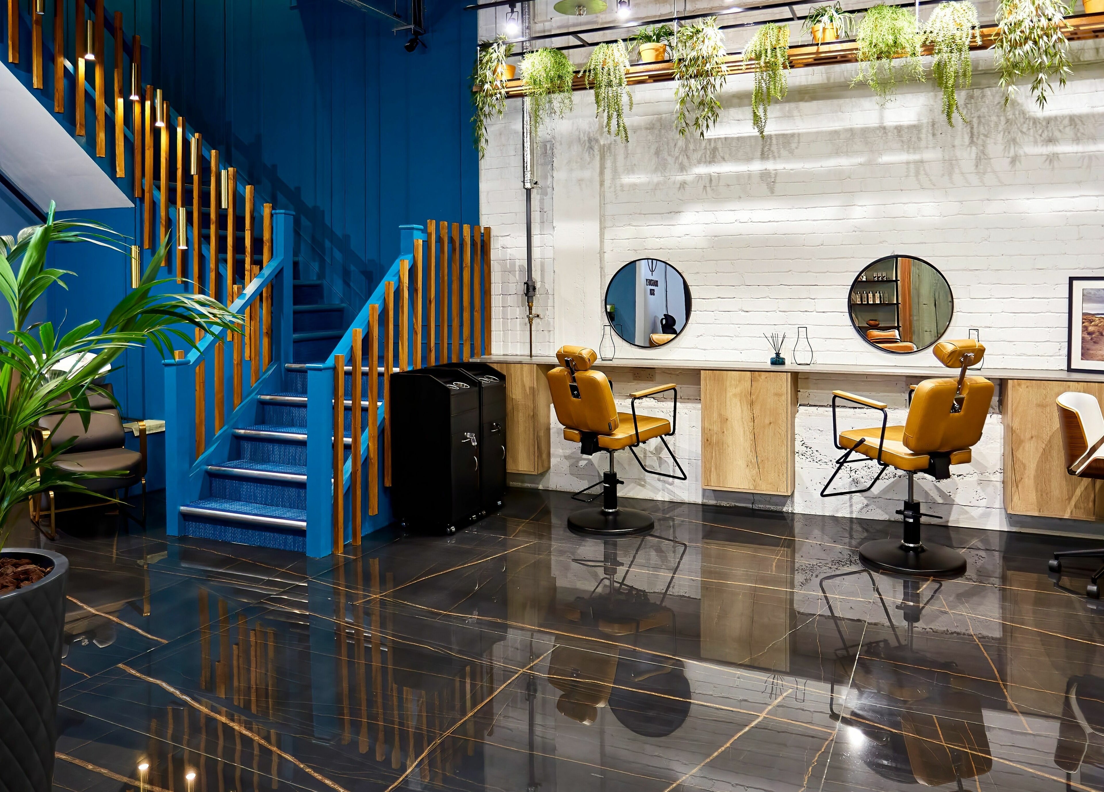 Stylish salon interior at Dragonfly Skin Day Spa, Leeds, England, GB with sleek chairs and lush plants.