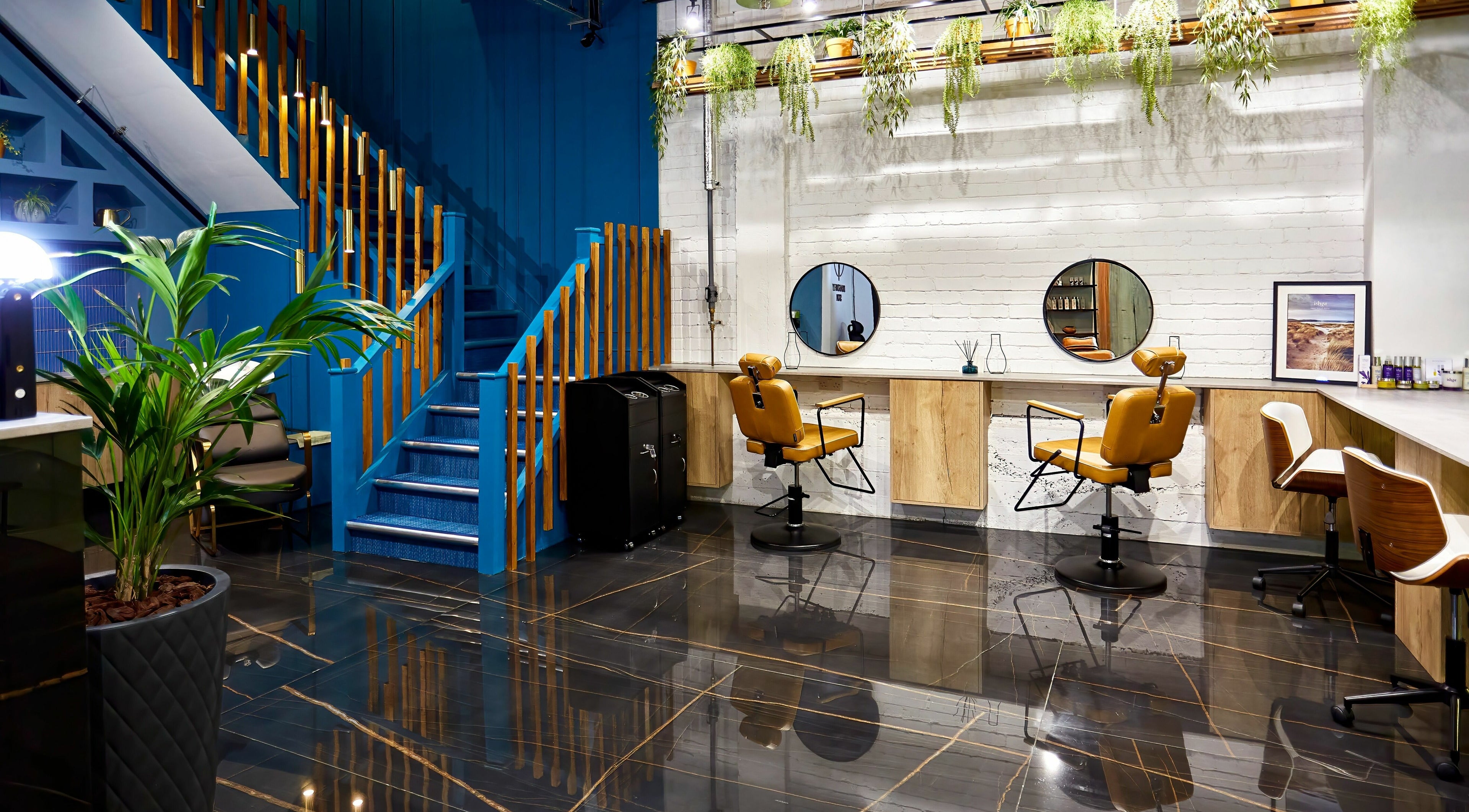 Stylish salon interior at Dragonfly Skin Day Spa, Leeds, England, GB with sleek chairs and lush plants.