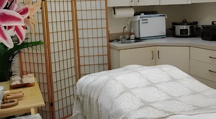 Relaxing spa room at Andreia Schweich in Lake Mary, Florida, US with a massage bed and calming decor.