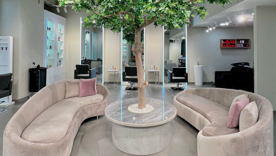 Modern beauty salon with elegant seating and tree decor at Salaza Gibran Khabbaz in Dubai, Dubai, AE.