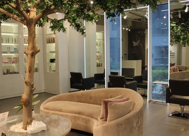 Elegant seating area inside Salaza Gibran Khabbaz, Dubai, Dubai, AE, featuring modern decor and lush greenery.