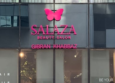 Exterior signage of Salaza Gibran Khabbaz beauty salon in Dubai, Dubai, AE. Features a pink butterfly logo.