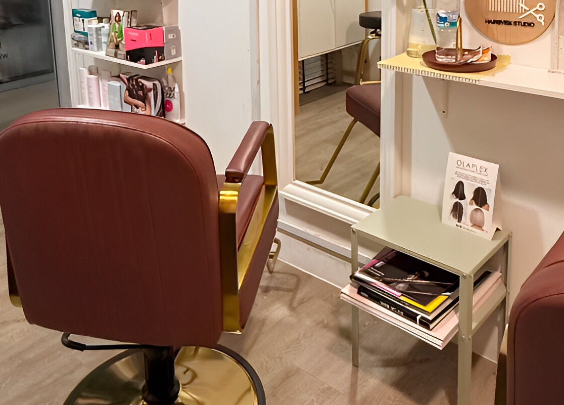 Stylish interior of HairByIsk Studio in Singapore, SG featuring a modern salon chair and chic decor.