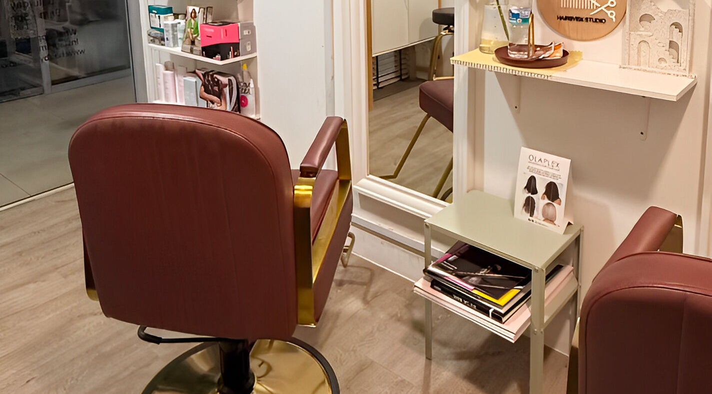 Stylish interior of HairByIsk Studio in Singapore, SG featuring a modern salon chair and chic decor.
