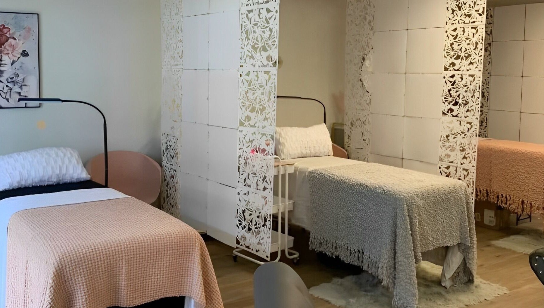 Cozy treatment beds at The Skin and Brow Spot in Countryside, Illinois, US with delicate white dividers.