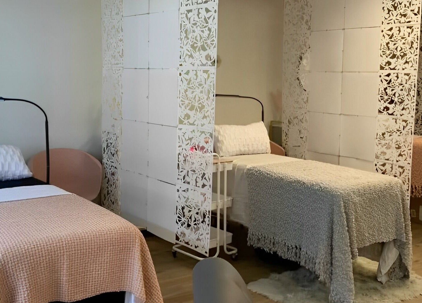 Cozy treatment beds at The Skin and Brow Spot in Countryside, Illinois, US with delicate white dividers.