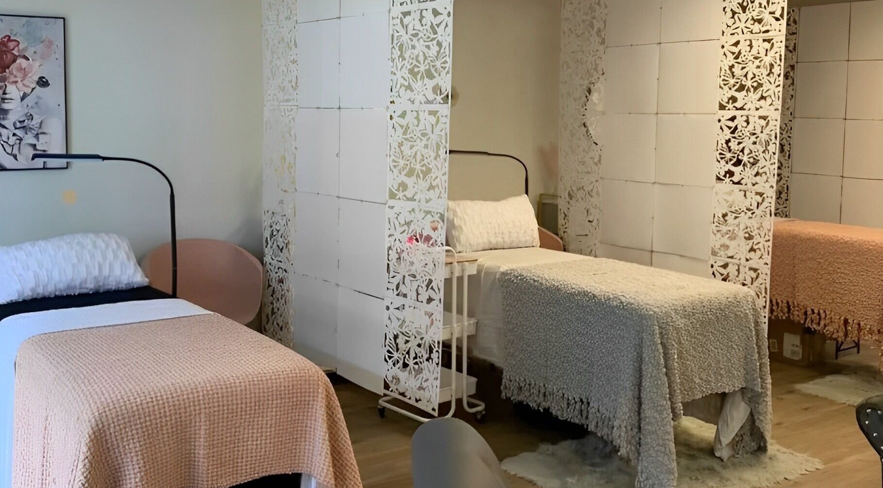 Cozy treatment beds at The Skin and Brow Spot in Countryside, Illinois, US with delicate white dividers.