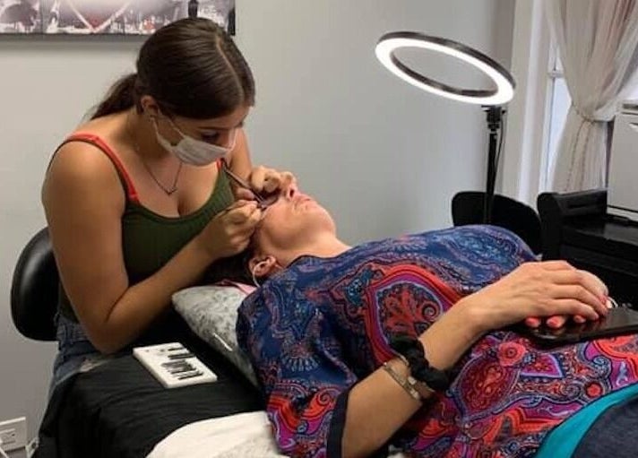 Aesthetician at The Skin and Brow Spot in Countryside, Illinois, US, applying eyelash extensions to a client.
