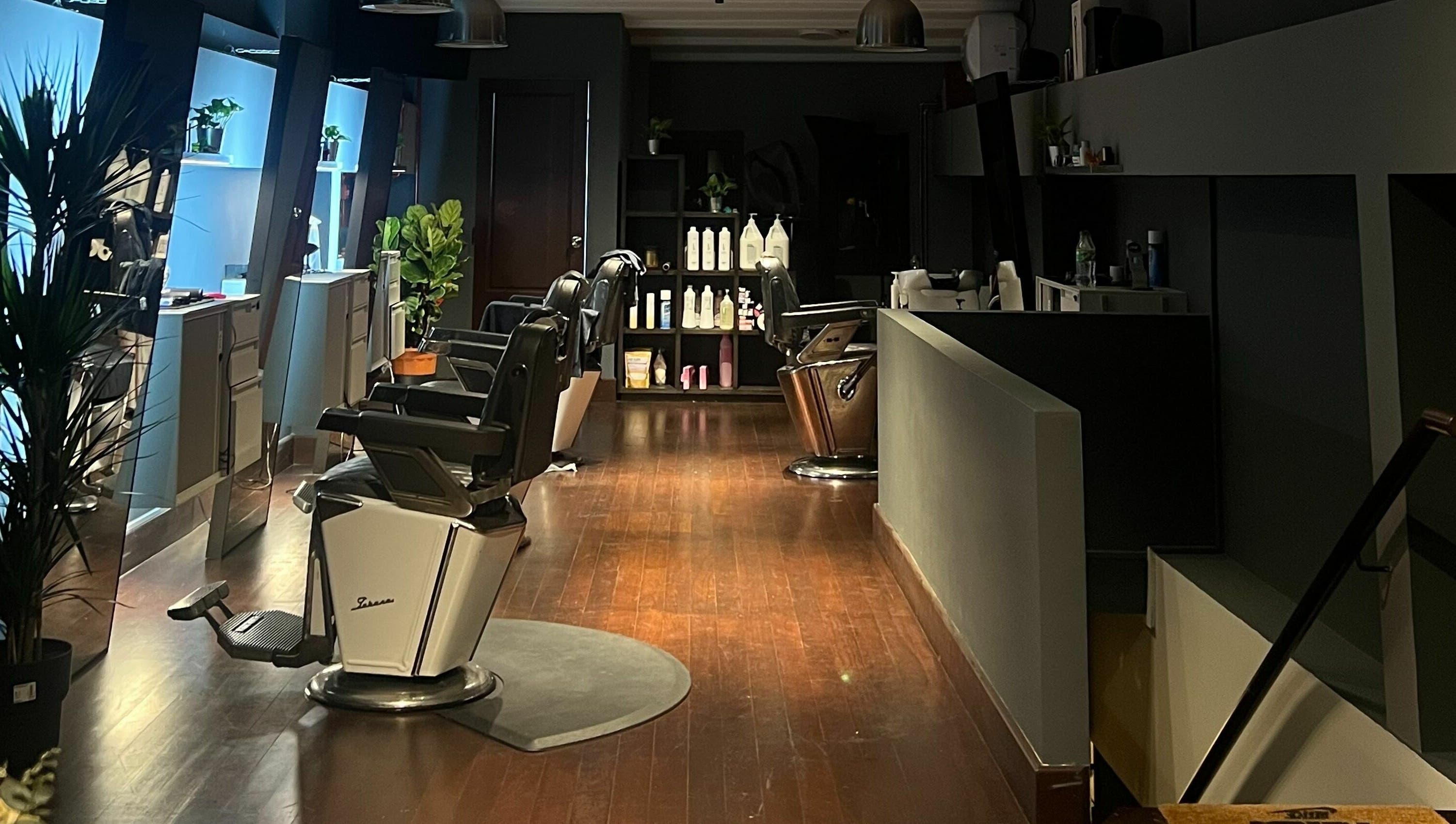 Modern barbershop interior at The Podium Salon & Barber .Co -Haji Lane-, Singapore, Singapore, SG, showcasing plush barber chairs.