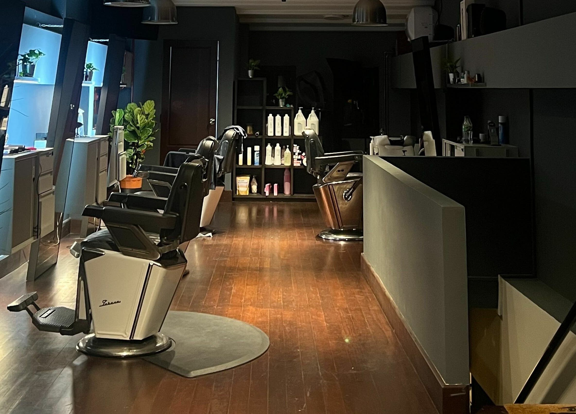 Modern barbershop interior at The Podium Salon & Barber .Co -Haji Lane-, Singapore, Singapore, SG, showcasing plush barber chairs.