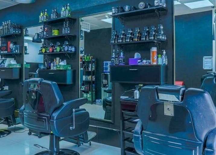 Modern interior of Fadez Gents Salon in Dubai, AE with stylish chairs and grooming products.