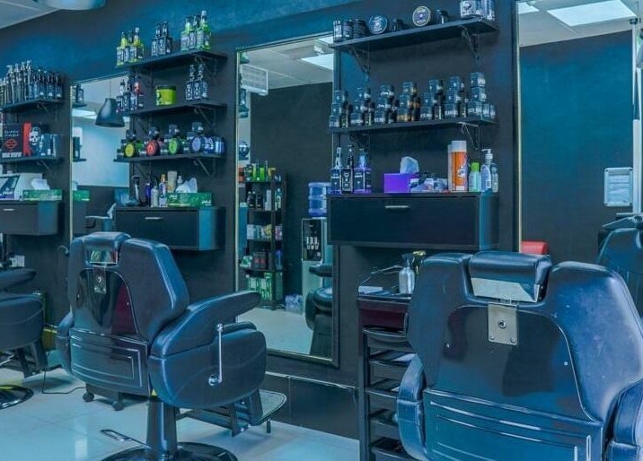 Modern interior of Fadez Gents Salon in Dubai, AE with stylish chairs and grooming products.
