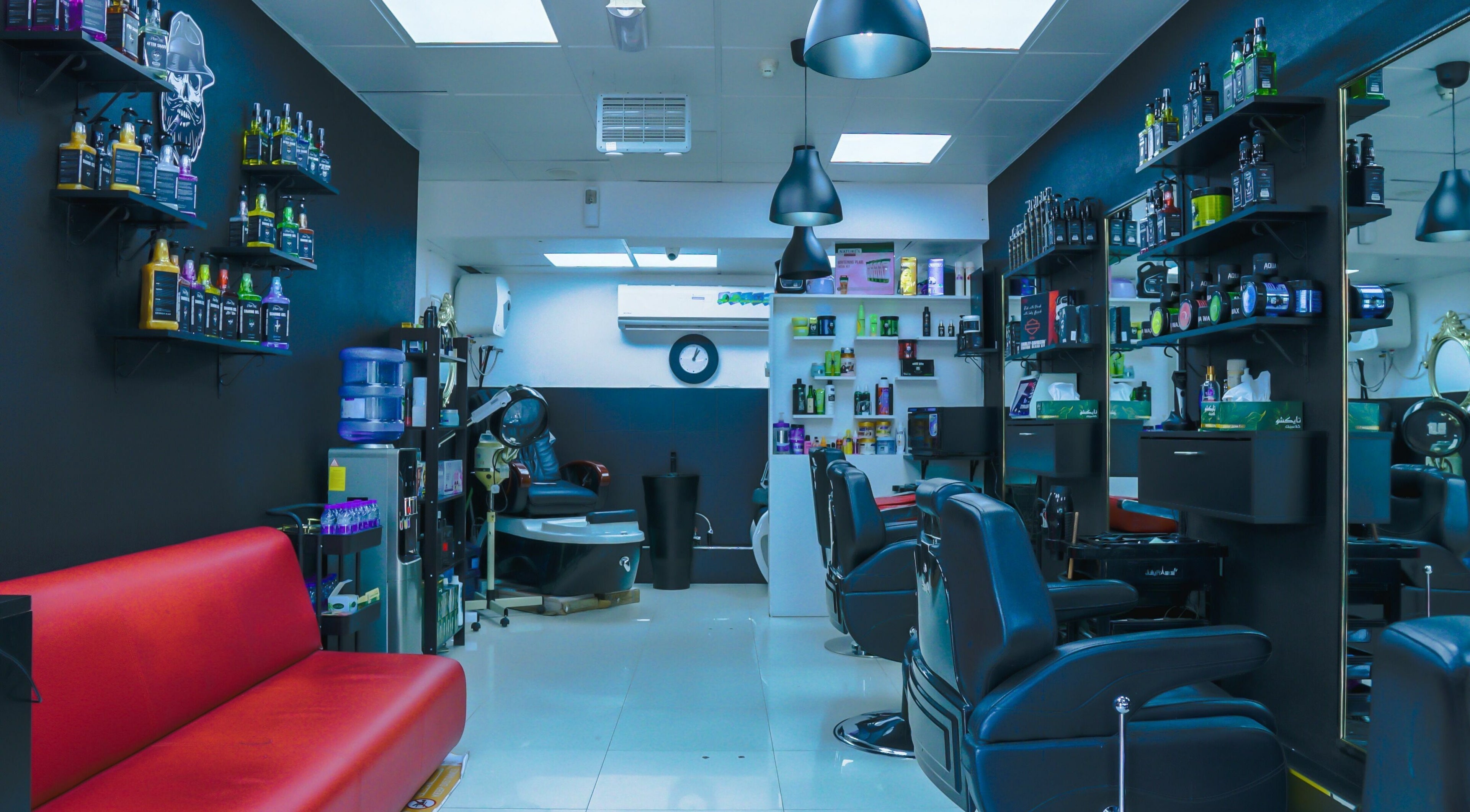 Modern interior of Fadez Gents Salon in Dubai, AE, featuring sleek chairs and product shelves.