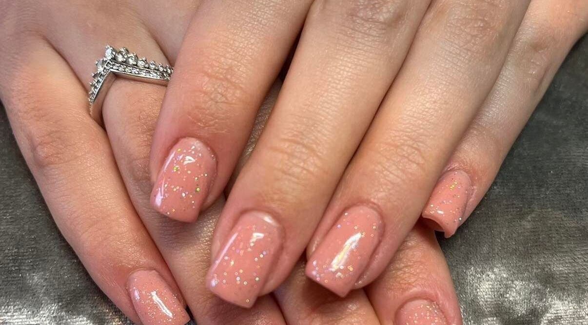 Sparkling pink nails with glitter shine at Pretty Beautiful, Waterlooville, England, GB.
