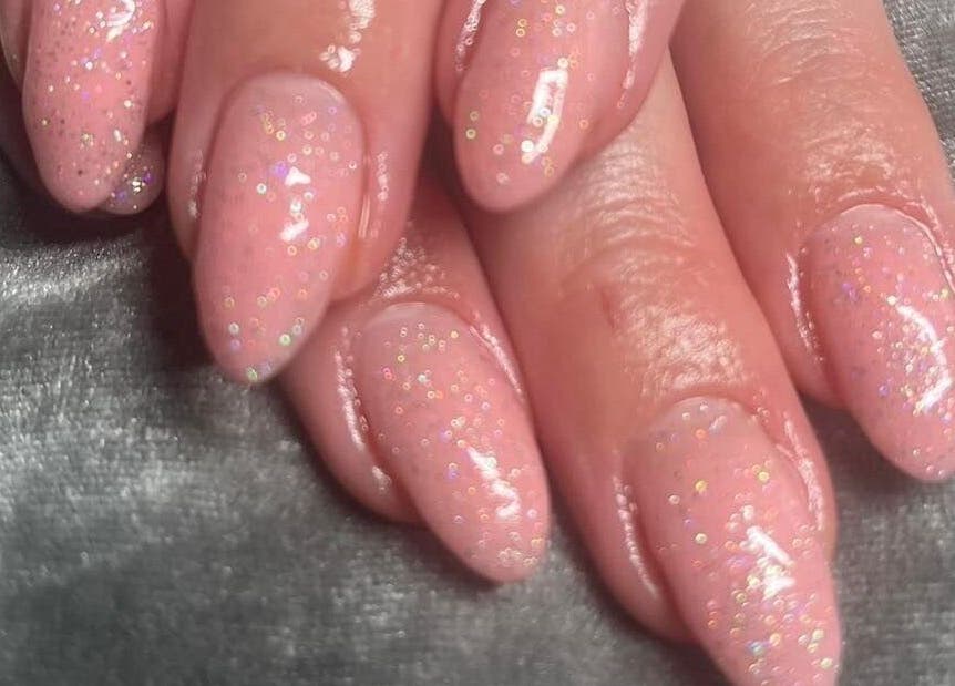Glittery pink nails at Pretty Beautiful, Waterlooville, England, GB showcasing elegant manicure art.