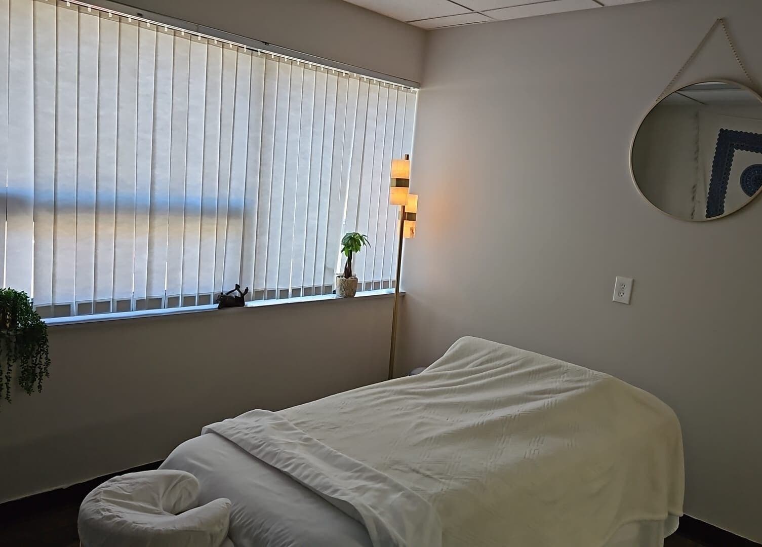 Peaceful massage room at Legend Wellness Center - Yonkers, New York, US, featuring a cozy table and soft lighting.