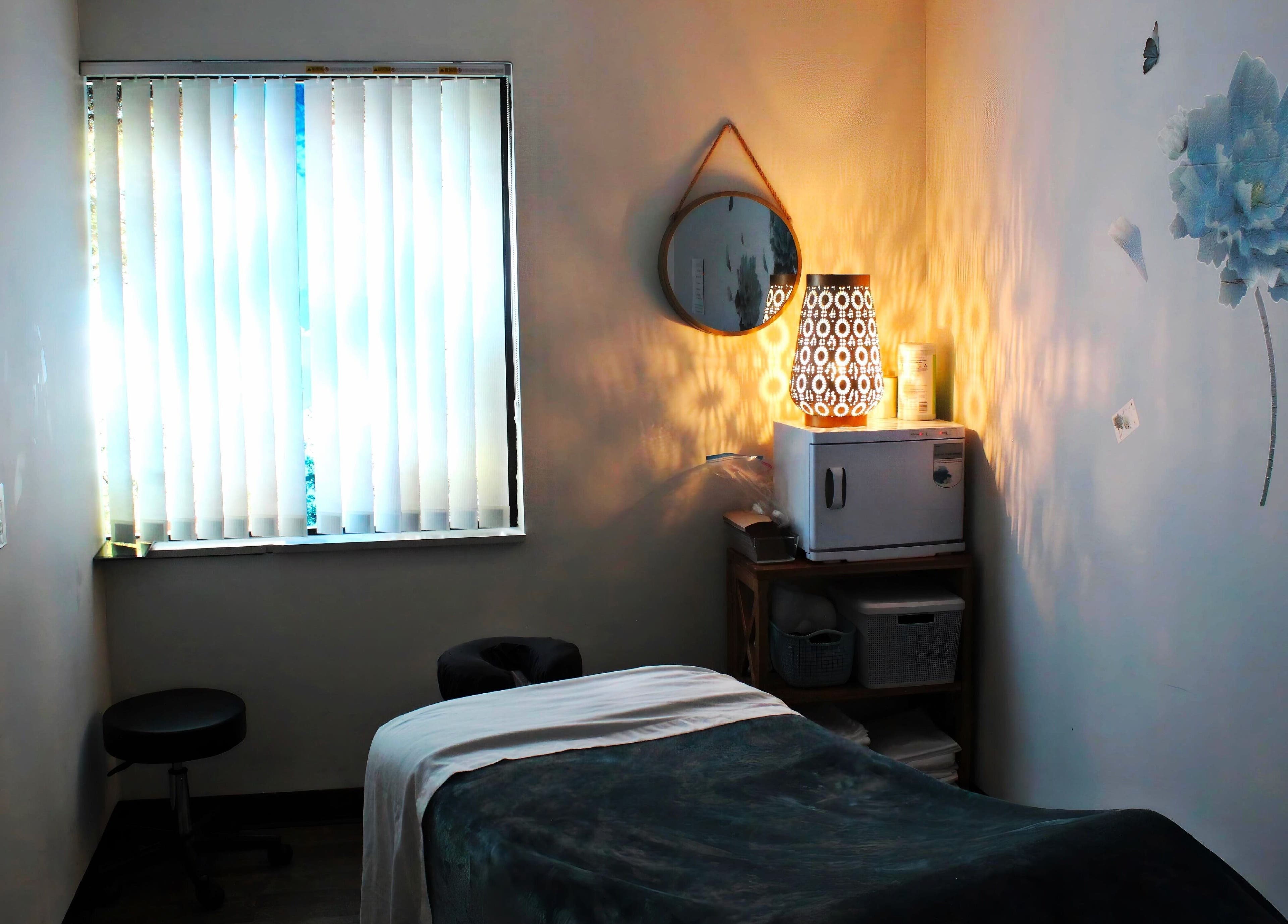 Serene massage room at Legend Wellness Center - Yonkers, Yonkers, New York, US, with soft lighting and decor.