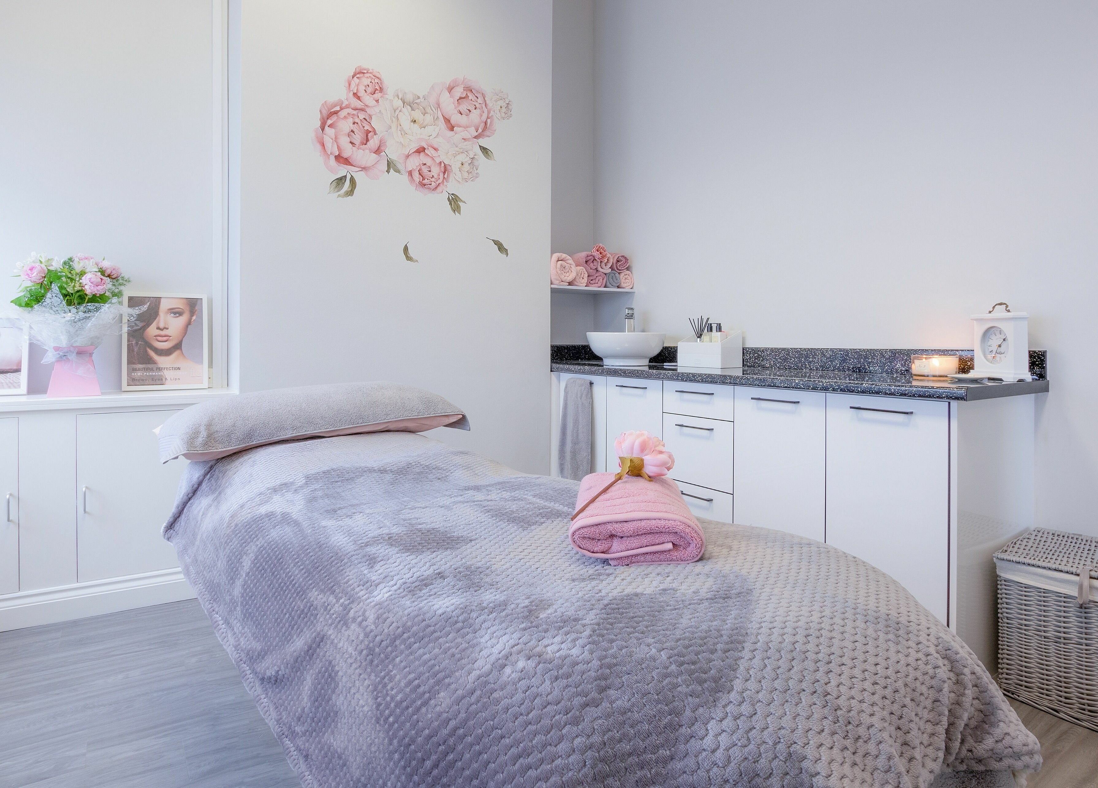 Tranquil treatment room at Forever Beautiful, Wooler, England, GB, with soft decor and floral accents.
