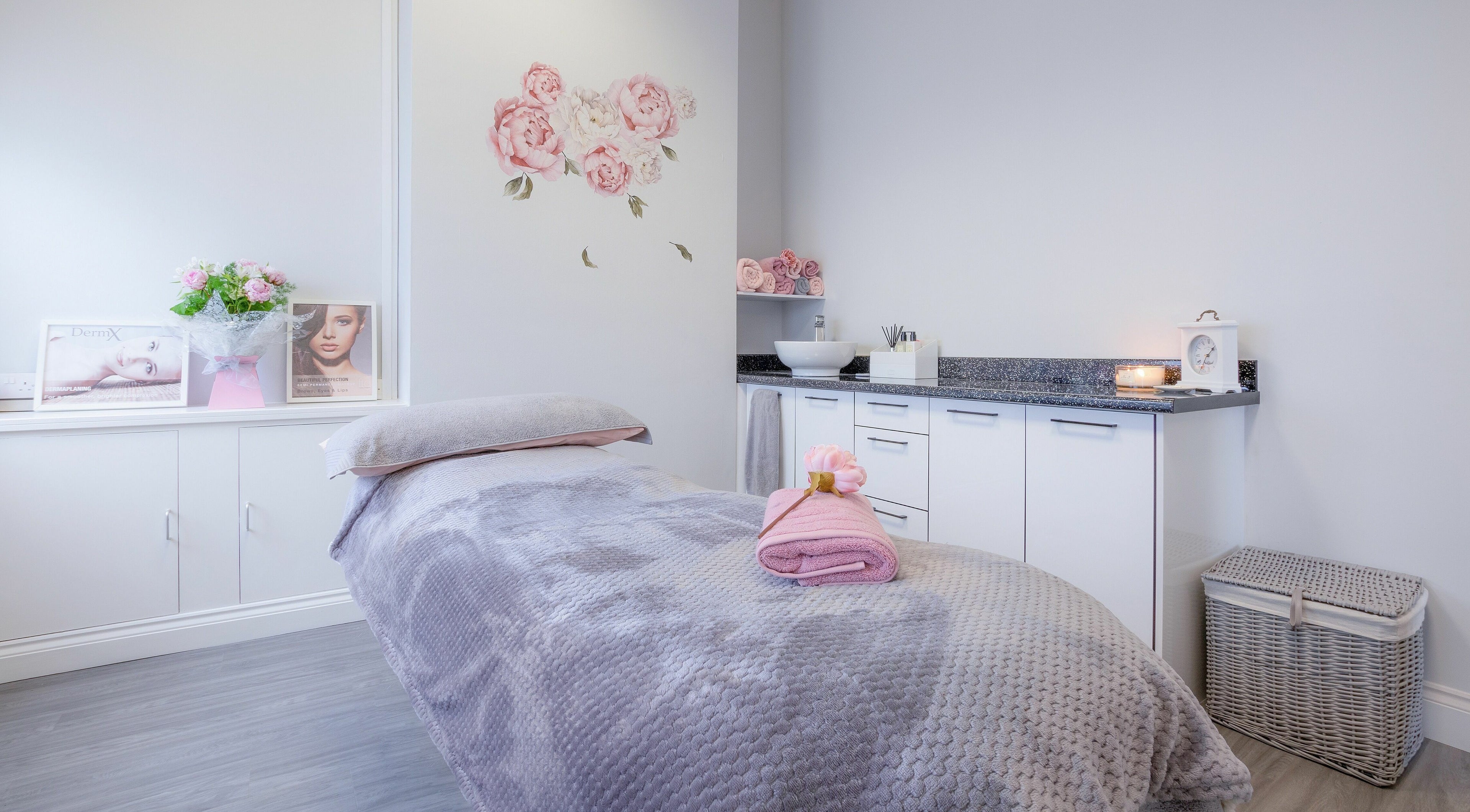 Tranquil treatment room at Forever Beautiful, Wooler, England, GB, with soft decor and floral accents.