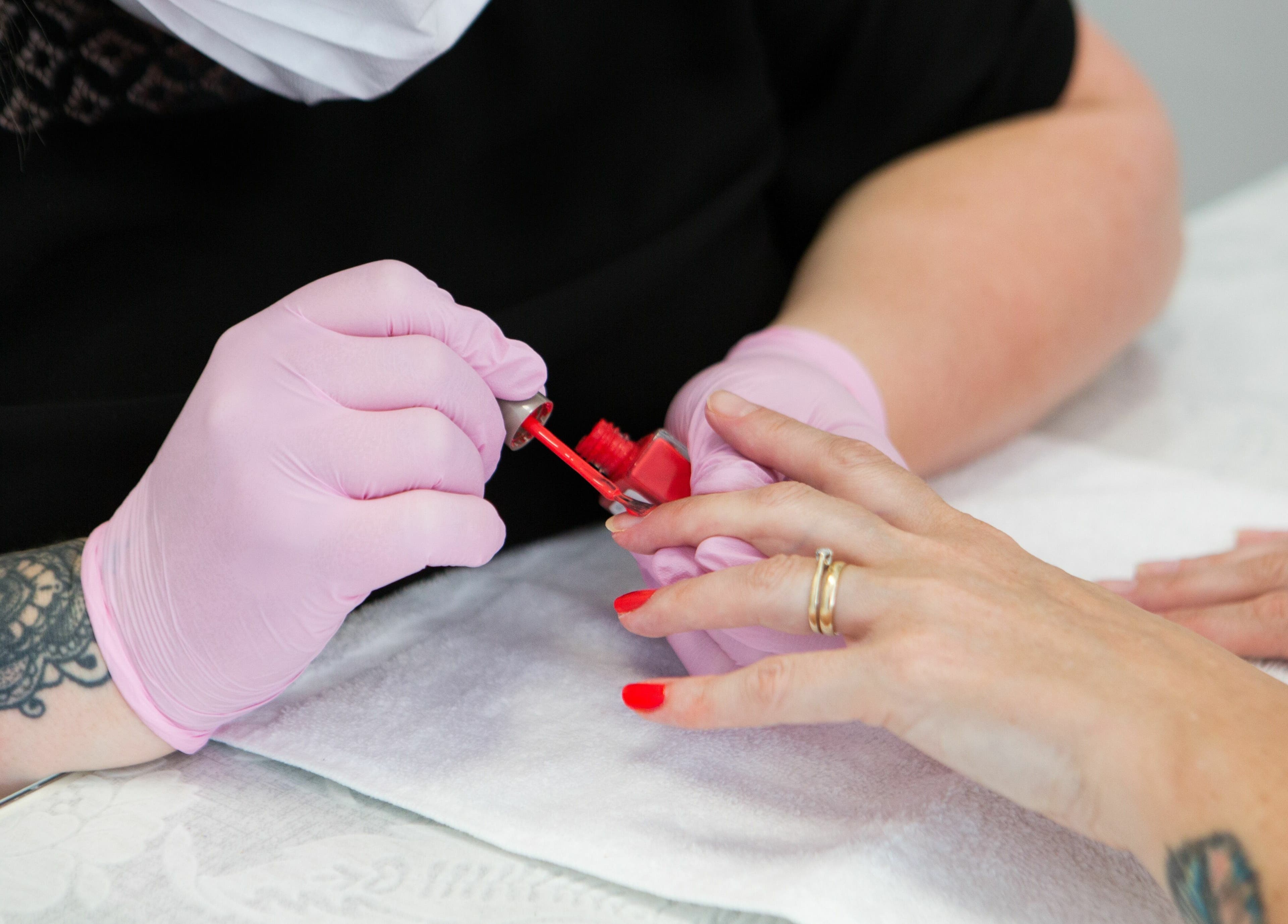 Professional manicure at Forever Beautiful, Wooler, England, GB. Hands and red polish.
