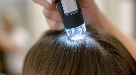 Scalp analysis at Beauty By Marina in Thetford, England, GB, using a lighted magnifier for hair health.