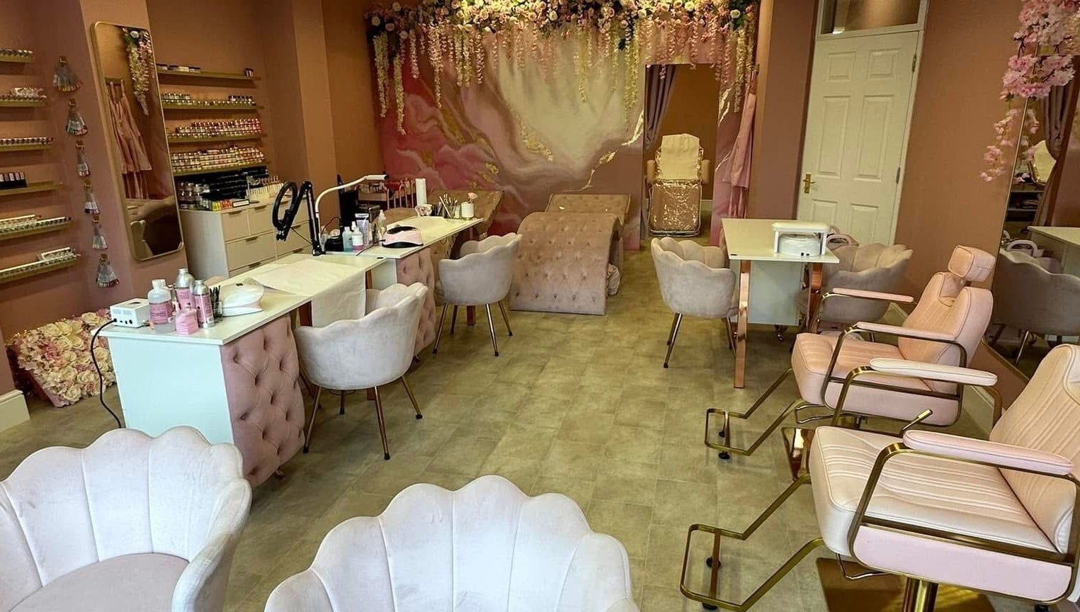 Stylish interior of Artistry Clinic in Rotherham, England, GB showcasing elegant pink decor and modern chairs.