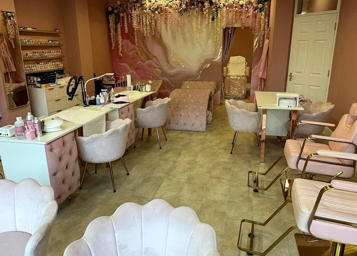 Stylish interior of Artistry Clinic in Rotherham, England, GB showcasing elegant pink decor and modern chairs.