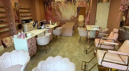Stylish interior of Artistry Clinic in Rotherham, England, GB showcasing elegant pink decor and modern chairs.