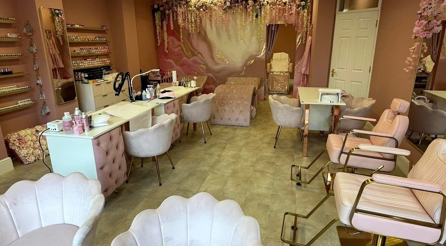 Stylish interior of Artistry Clinic in Rotherham, England, GB showcasing elegant pink decor and modern chairs.