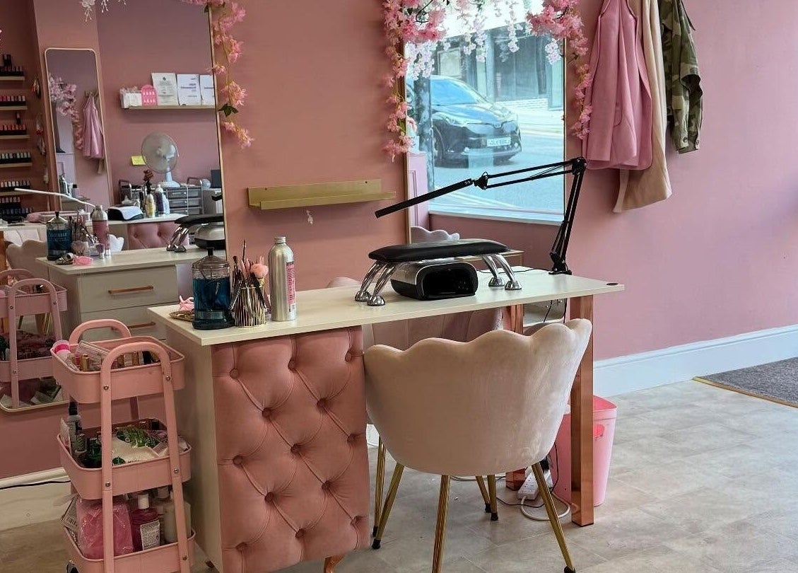 Chic nail station at Artistry Clinic in Rotherham, England. Pink decor enhances the tranquil atmosphere.