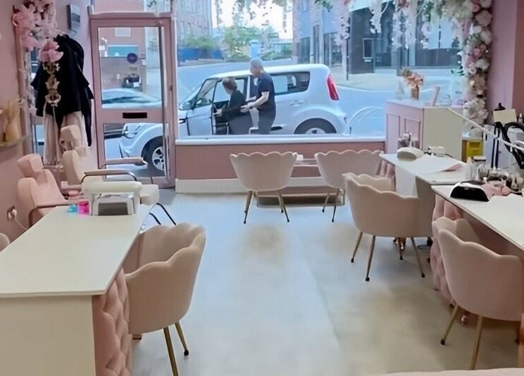 Elegant salon interior at Artistry Clinic in Rotherham, England, GB with chic pink decor and comfortable seating.