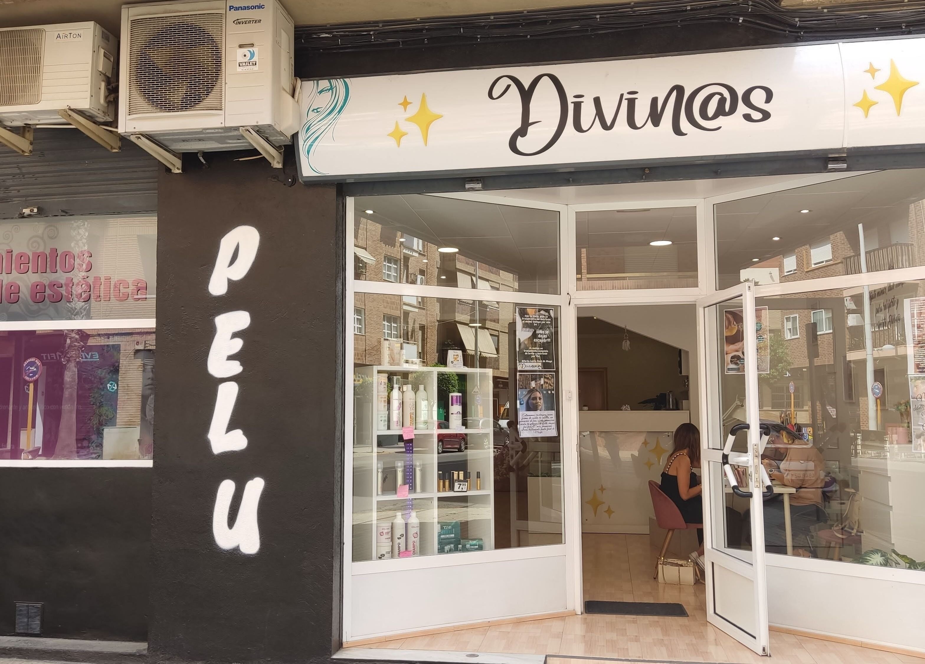 Fachada de Divinas Look Pelu en Paiporta, Comunidad Valenciana, ES, mostrando entrada y escaparate elegante.