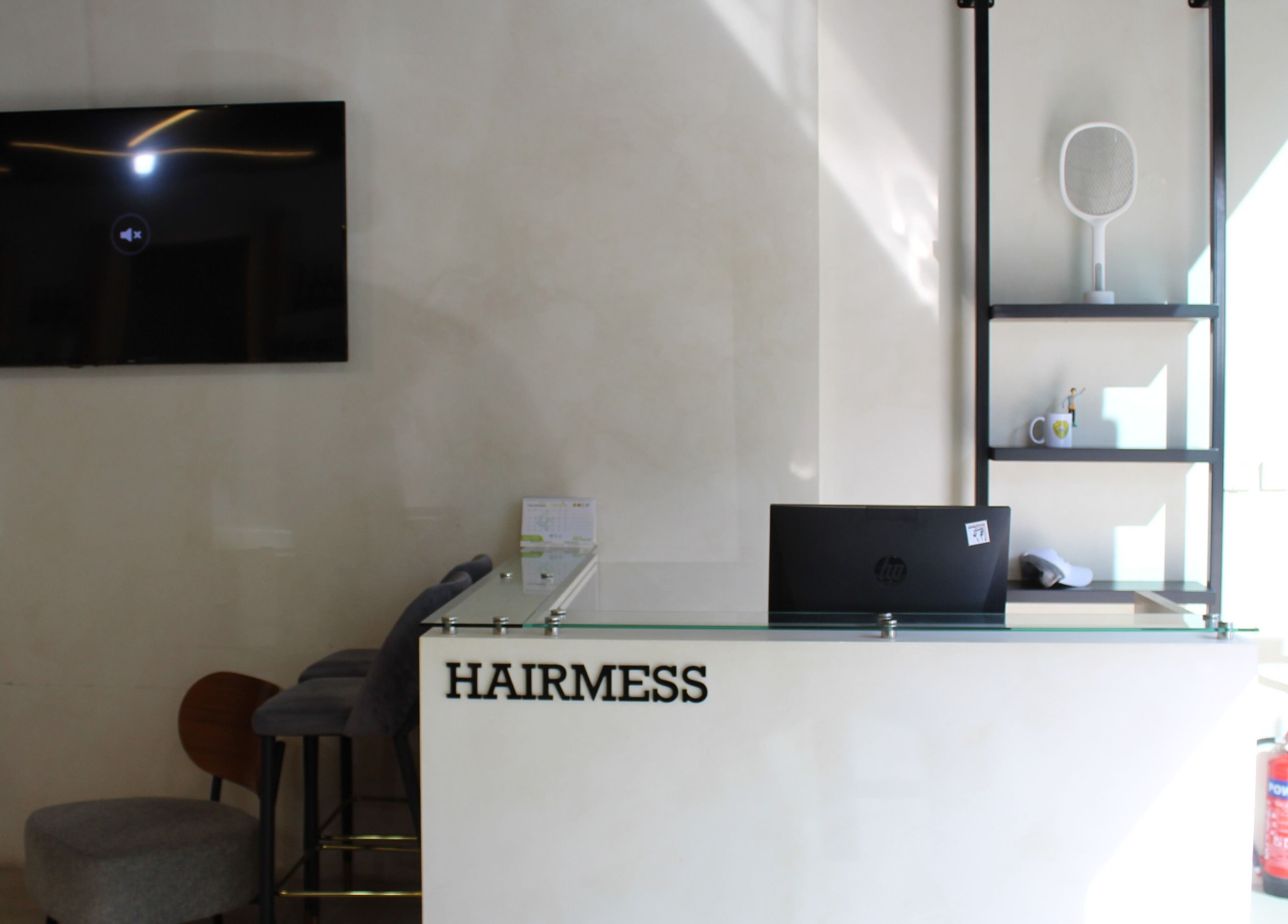 Reception area of Hairmess in Dubai, Dubai, AE, featuring a sleek desk and modern decor.