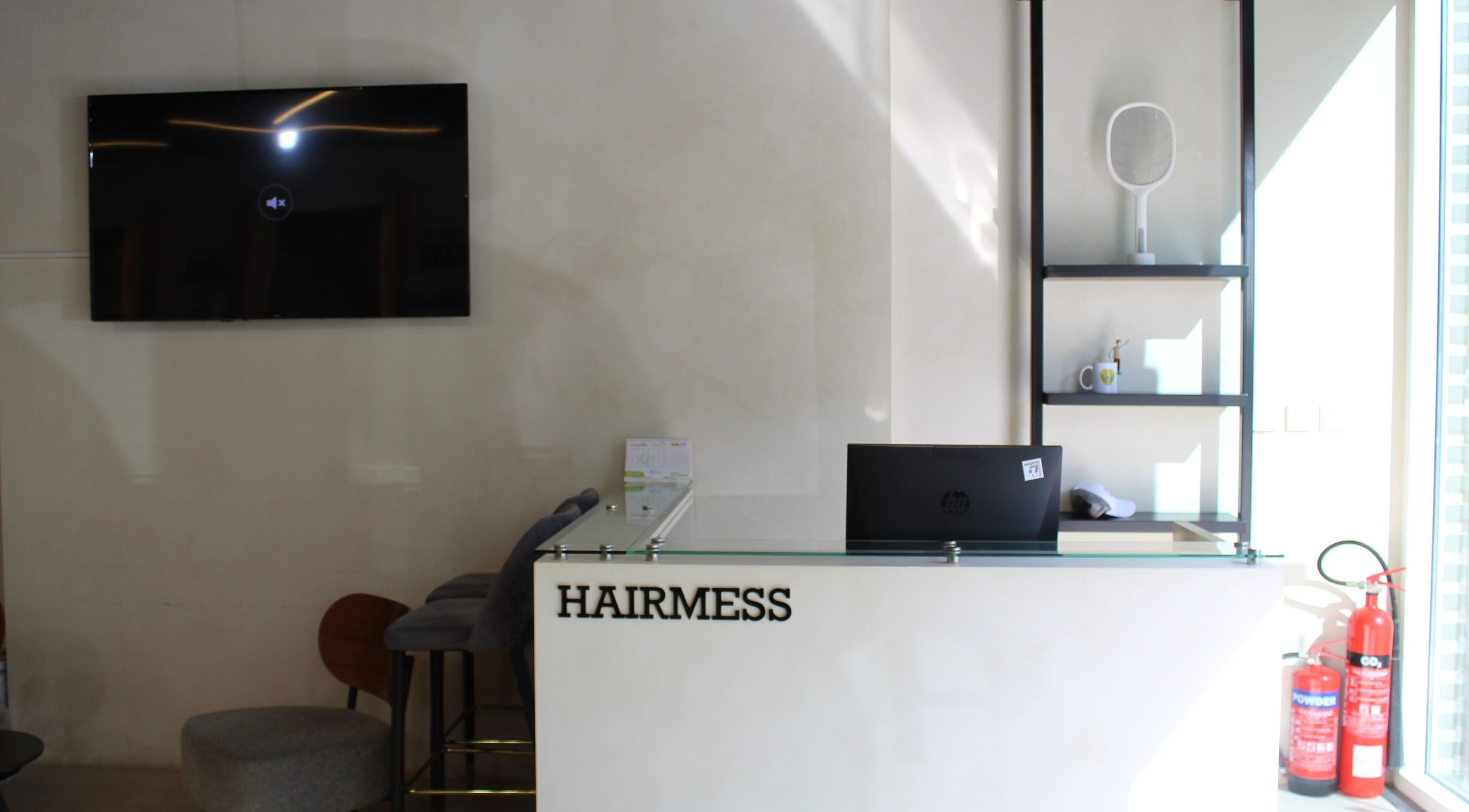 Reception area of Hairmess in Dubai, Dubai, AE, featuring a sleek desk and modern decor.