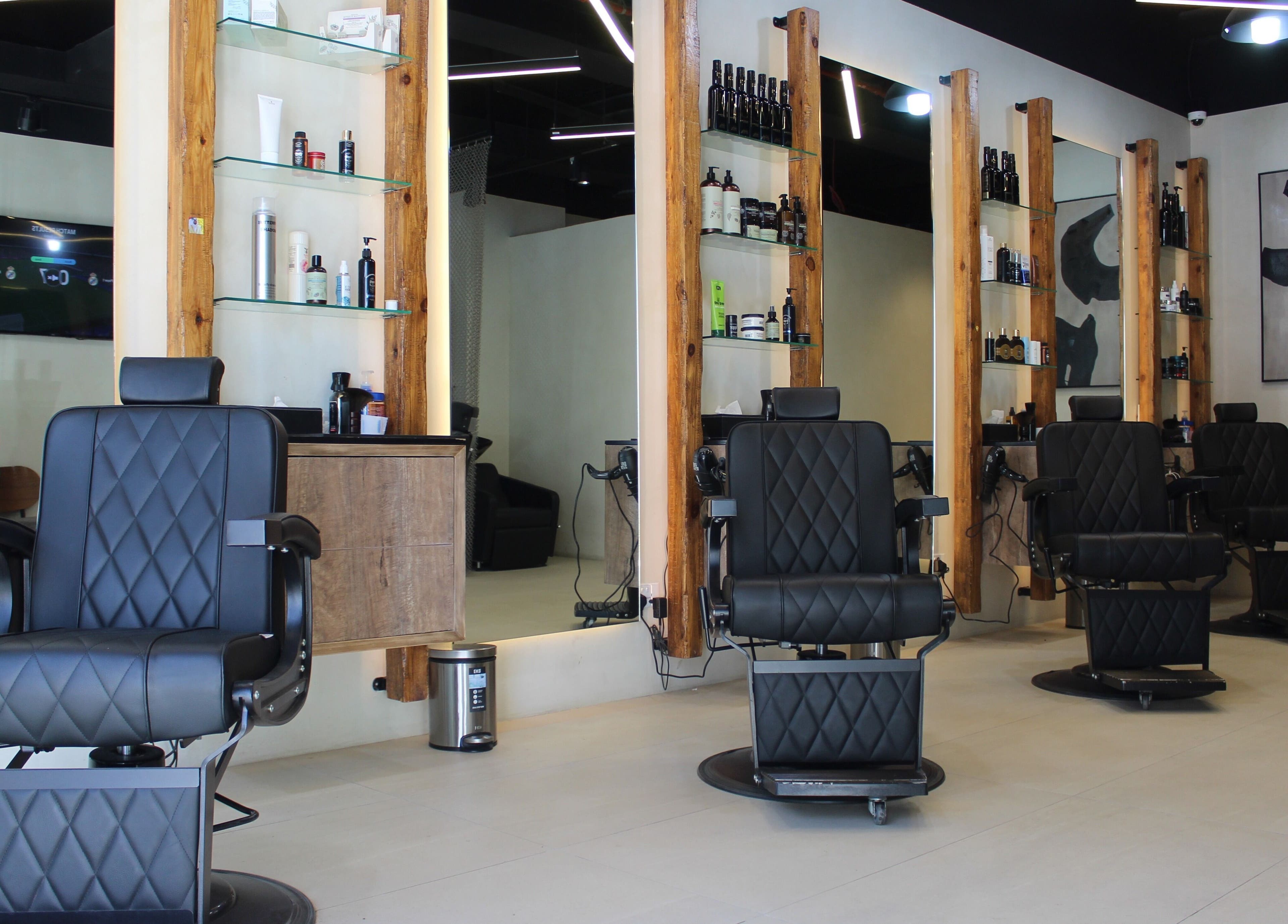 Modern salon chairs at Hairmess, Dubai, Dubai, AE accentuate the sophisticated interior decor.