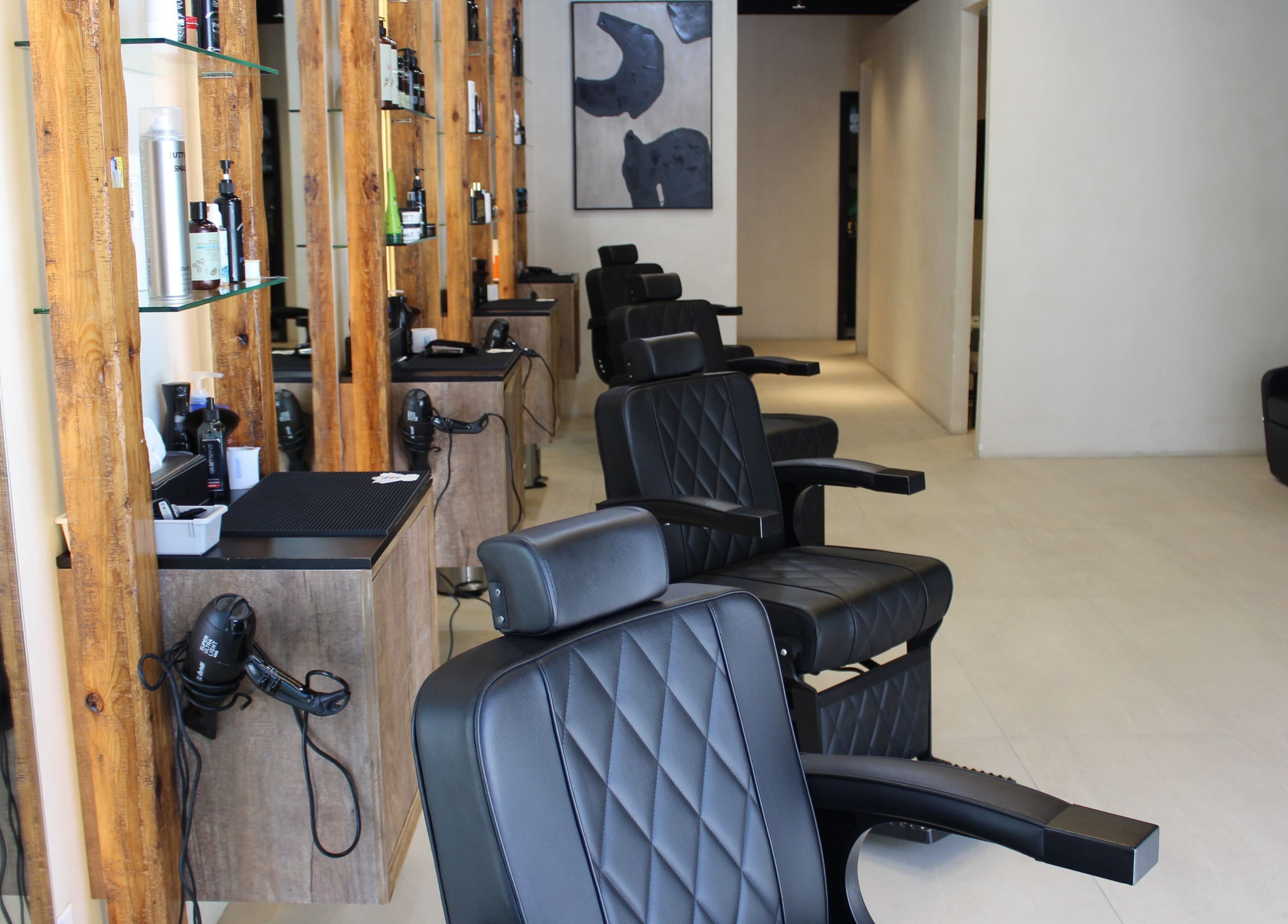 Modern salon chairs at Hairmess, Dubai, Dubai, AE with stylish wood accents and sleek décor.