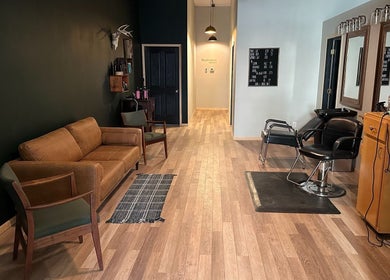 Contemporary salon interior at The Body Shoppe, Darlington, Wisconsin, US, with stylish seating and mirrors.