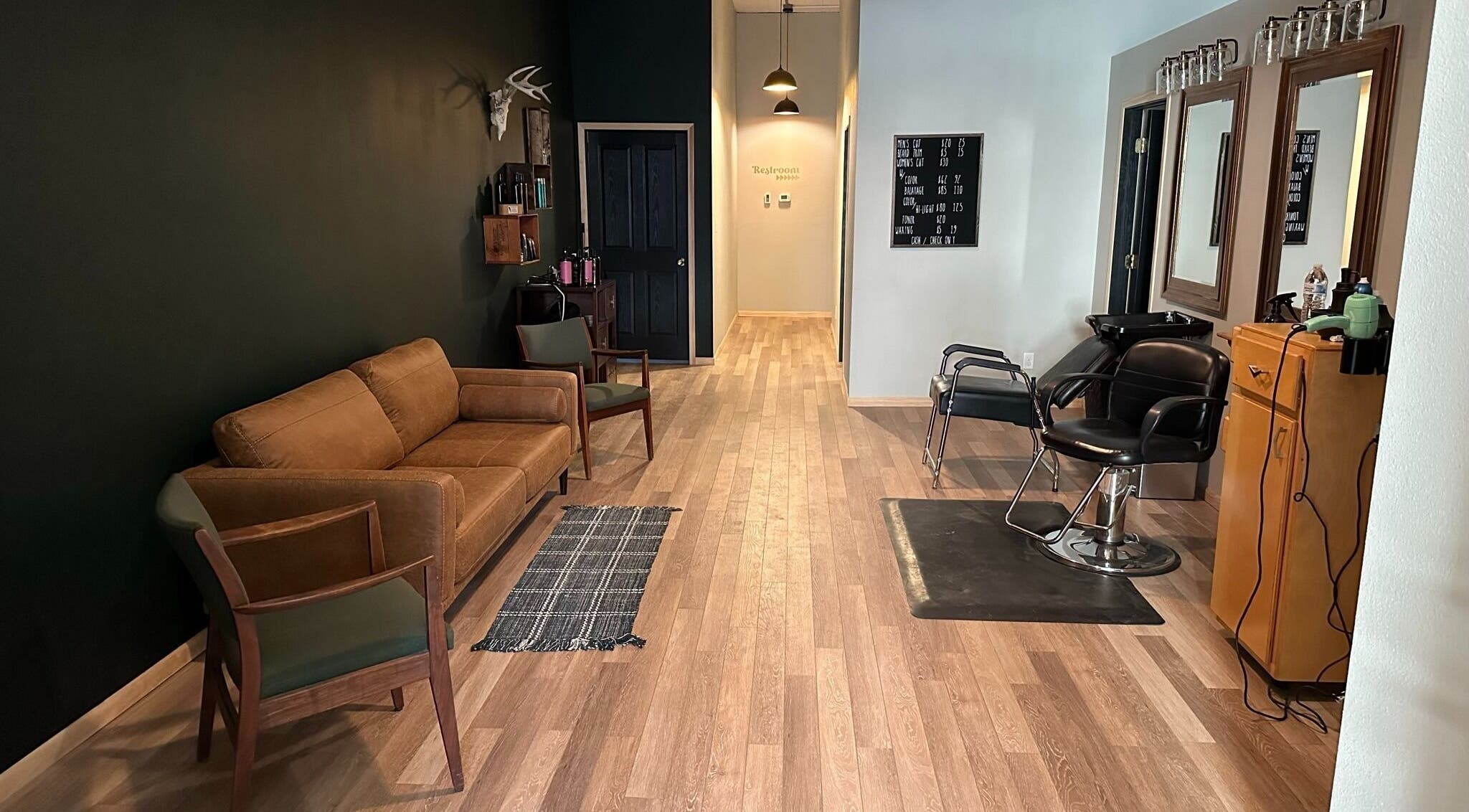 Contemporary salon interior at The Body Shoppe, Darlington, Wisconsin, US, with stylish seating and mirrors.