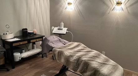 Cozy treatment room at The Body Shoppe in Darlington, Wisconsin, US with ambient lighting and comfortable bed.