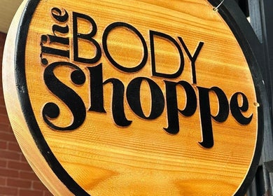 Elegant wooden sign of The Body Shoppe in Darlington, Wisconsin, US, showcasing its classic style.