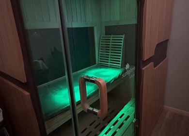 Relaxing sauna experience at The Body Shoppe, Darlington, Wisconsin, US with soothing green lighting.