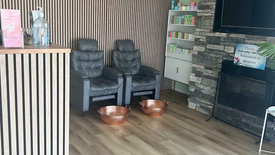 Relaxing lounge at Wandong Wellness Retreat, featuring chairs and warm decor in Wandong, Victoria, AU.