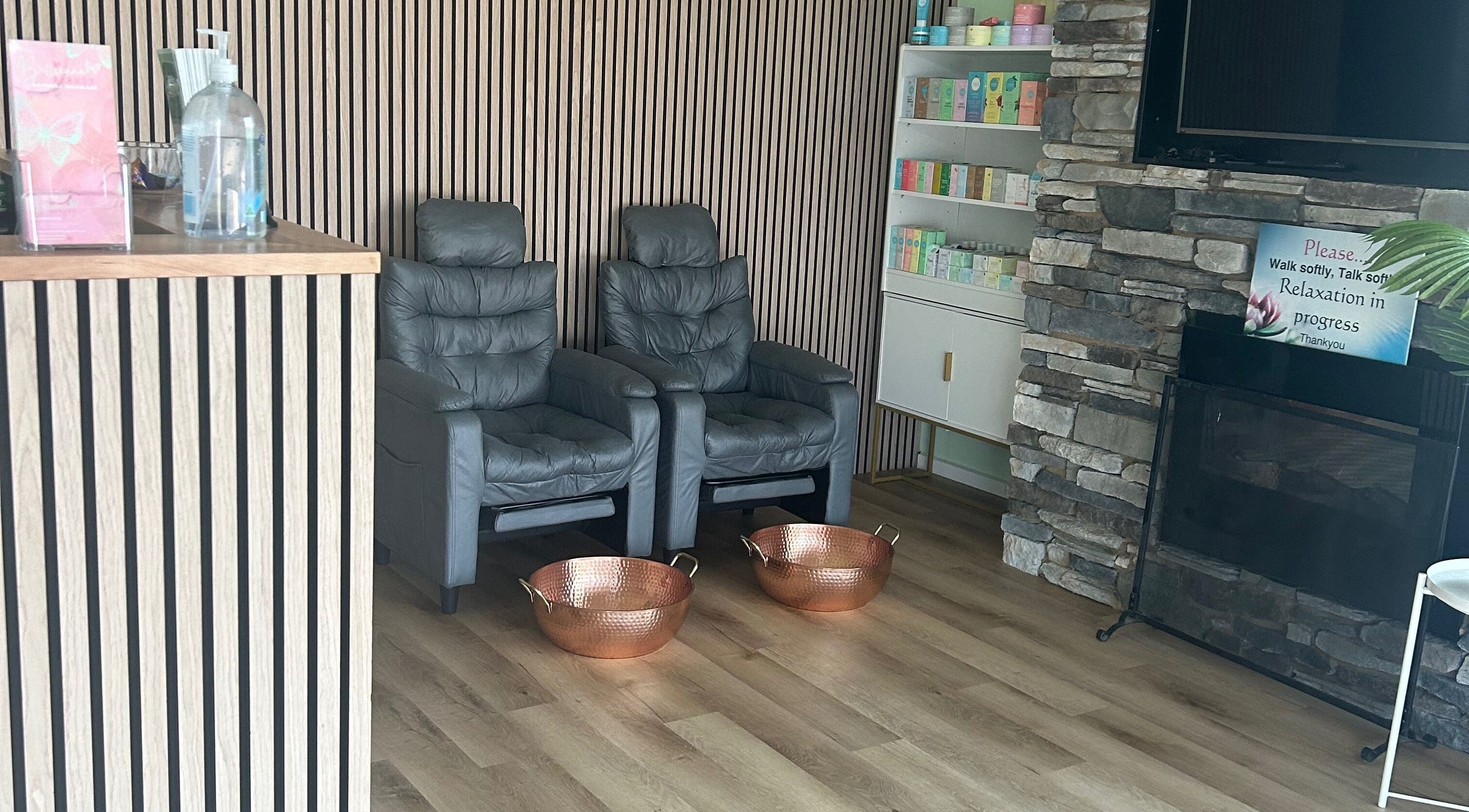 Relaxing lounge at Wandong Wellness Retreat, featuring chairs and warm decor in Wandong, Victoria, AU.