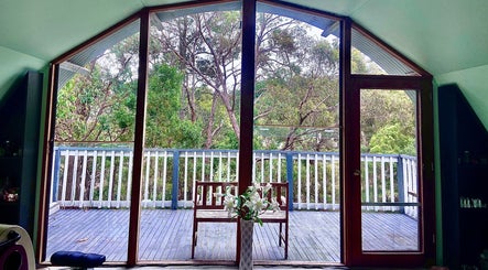 Serene deck view from Wandong Wellness Retreat in Wandong, Victoria, AU overlooking lush forest scenery.