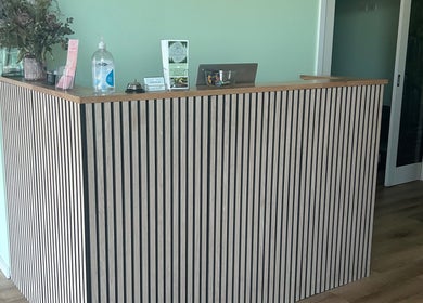 Modern reception desk at Wandong Wellness Retreat in Wandong, Victoria, AU, exuding a tranquil atmosphere.