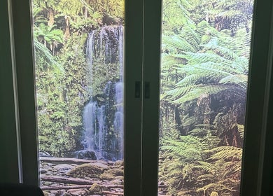 Waterfall mural at Wandong Wellness Retreat, Wandong, Victoria, AU, enhancing relaxation with nature imagery.