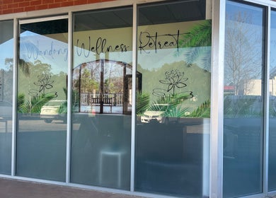 Exterior of Wandong Wellness Retreat featuring lush palm graphics in Wandong, Victoria, AU.