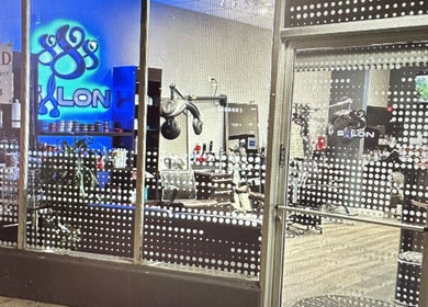 Stylish view of 888 Salon's entrance in Chicago, Illinois, US showcasing modern interior through glass.