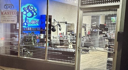 Stylish view of 888 Salon's entrance in Chicago, Illinois, US showcasing modern interior through glass.