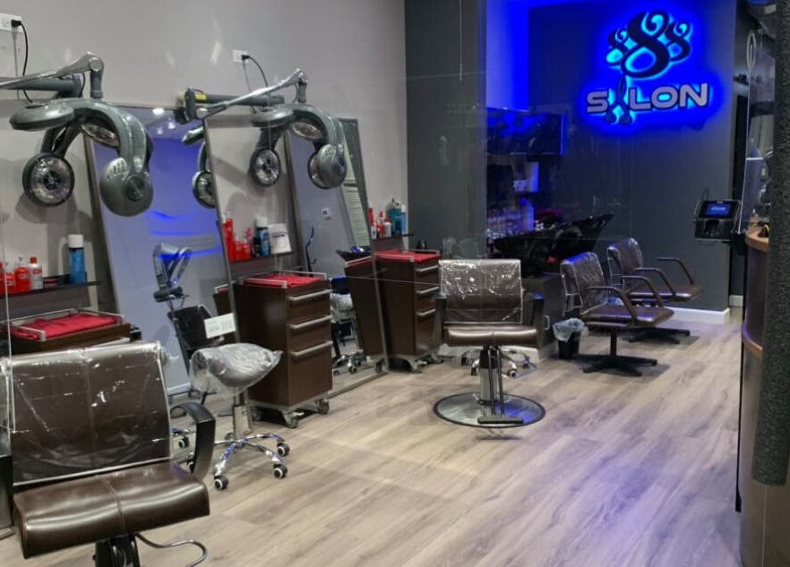 Modern styling chairs at Le Salon & Spa in Chicago, Illinois, US under soft lighting.